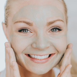 Woman washing her face with Zija GenM products.